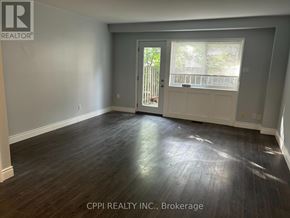 Toronto (Don Valley Village) townhouse for rent - A room with a wooden floor and a door leading outside.