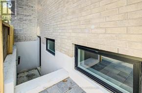 Toronto (Cliffcrest) apartment for rent - A view of a window and a door in a room with a brick wall.