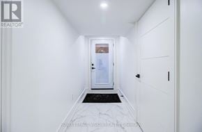 Toronto (Cliffcrest) apartment for rent - A hallway with white walls and a black and white marble floor leading to a door.