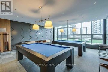 Toronto (Mimico) condo for rent - A pool table in a room with a view of the city.