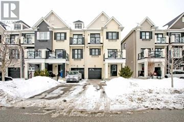 Whitchurch-Stouffville townhouse for rent - A row of townhouses with a car parked in front of the first one.