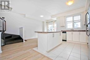 Whitchurch-Stouffville townhouse for rent - A spacious kitchen with white cabinets and a wooden countertop.