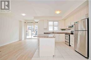 Whitchurch-Stouffville townhouse for rent - A kitchen with a refrigerator, oven, and microwave.
