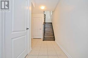 Whitchurch-Stouffville townhouse for rent - A hallway with a staircase leading to the second floor.