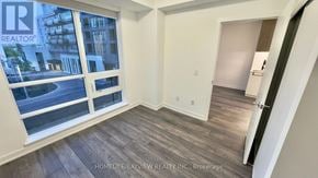 Richmond Hill (South Richvale) condo for rent - A room with a large window and wooden flooring.