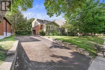 Toronto (Cliffcrest) apartment for rent - A residential area with a house, a bench, and a tree.