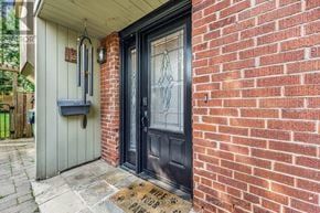 Toronto (Cliffcrest) apartment for rent - A black door with a glass window is set in a red brick wall.