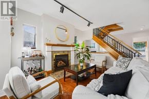 Toronto (Cliffcrest) apartment for rent - A living room with a fireplace and a staircase.