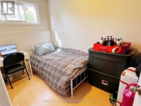 London North (North K) apartment for rent - A bedroom with a bed, chair, and a laptop on a desk.