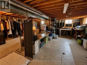 Ottawa apartment for rent - A room with a lot of clutter and a bed in the corner.