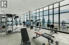 Toronto condo for rent - A gym with a view of the city skyline.