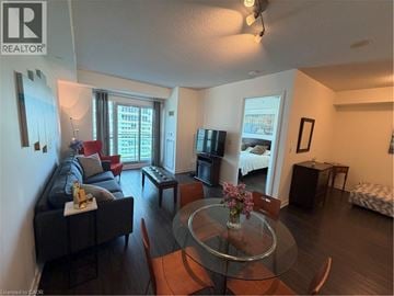Toronto condo for rent - A living room with a glass table and a couch.