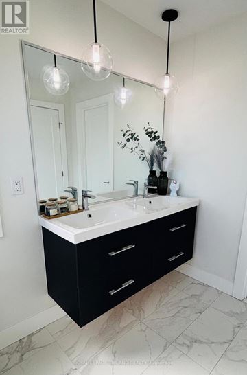 Middlesex Centre apartment for rent - A bathroom with a sink and a mirror.