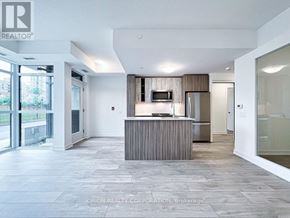 Toronto (Mimico) house for rent - A modern kitchen with a wooden island and a microwave above it.