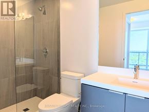 Toronto (Newtonbrook West) condo for rent - A bathroom with a walk-in shower, toilet, and sink.