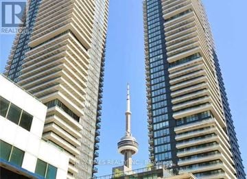 Toronto (Waterfront Communities) condo for rent - Two tall buildings with a CN Tower in the background.