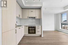Toronto (Banbury-Don Mills) condo for rent - A modern kitchen with white cabinets and a stainless steel oven.