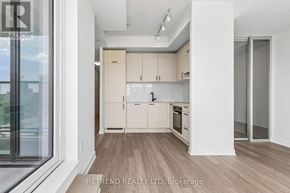 Toronto (Banbury-Don Mills) condo for rent - A kitchen with white cabinets and a wooden floor.