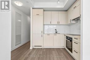 Toronto (Banbury-Don Mills) condo for rent - A kitchen with wooden cabinets and a stove top oven.