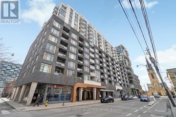 Toronto (Waterfront Communities) condo for rent - A tall building with a sign that says "REALTOR" on the top left corner.