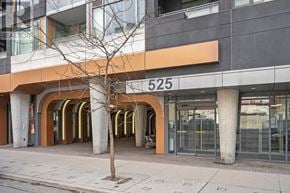 Toronto (Waterfront Communities) condo for rent - A tree stands in front of a building with the number 525 on it.