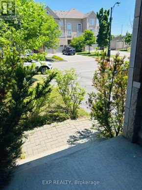 Vaughan (Vellore Village) townhouse for rent - A view of a residential street with a house and parked cars.