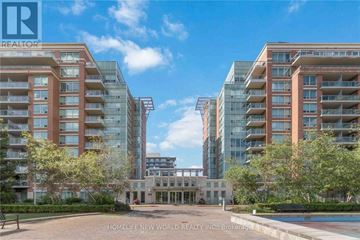 Markham (Commerce Valley) condo for rent - A large building with the letters "R" on it is surrounded by other large buildings.