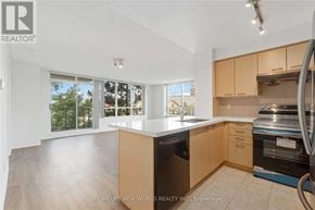 Markham (Commerce Valley) condo for rent - A kitchen with wooden cabinets and a stainless steel dishwasher.