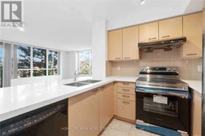 Markham (Commerce Valley) condo for rent - A kitchen with a white countertop and wooden cabinets.