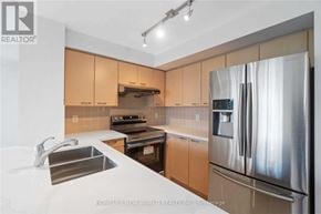 Markham (Commerce Valley) condo for rent - A modern kitchen with a stainless steel refrigerator, sink, and oven.