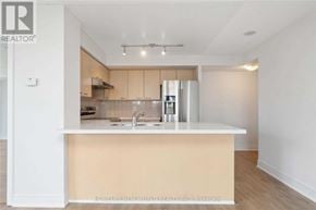 Markham (Commerce Valley) condo for rent - A modern kitchen with a white countertop and stainless steel appliances.