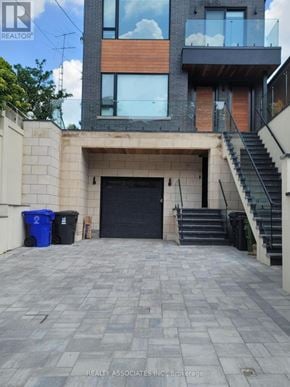Toronto (Caledonia-Fairbank) apartment for rent - A modern house with a black door and a staircase leading to the second floor.