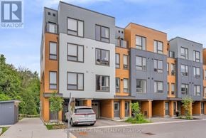 Oshawa (Samac) townhouse for rent - A modern apartment building with a car parked in front.