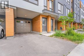 Oshawa (Samac) townhouse for rent - A modern house with a grey garage door and a brown door.
