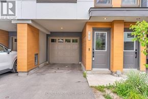 Oshawa (Samac) townhouse for rent - A white car is parked in front of a house with a Royal LePage REALTY sign.