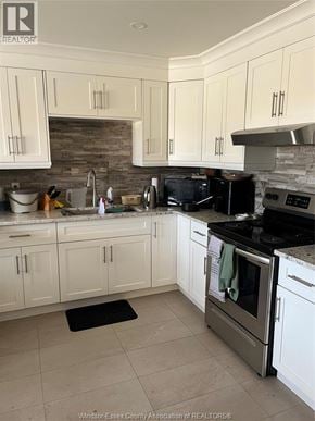 Windsor apartment for rent - A kitchen with white cabinets and a black stove top oven.