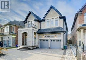 Milton (Fo Ford) apartment for rent - A large, two-story house with a stone facade and a black roof is for sale.