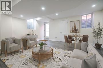 Milton apartment for rent - A living room with a grey sofa, a wooden coffee table, and a rug with a geometric pattern.