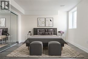 Milton apartment for rent - A bedroom with a bed, two chairs, and a rug.