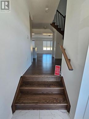 Kitchener apartment for rent - A hallway with a wooden staircase leading to the second floor.