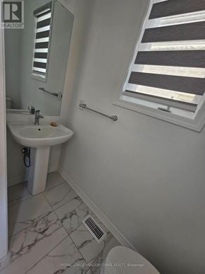 Kitchener apartment for rent - A white sink in a bathroom with a mirror above it.