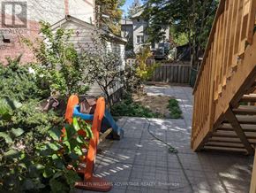 Toronto (Woodbine Corridor) apartment for rent - A backyard with a wooden play structure and a green hose.