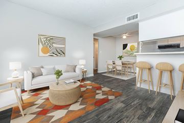 Phoenix apartment for rent - A living room with a white couch, a coffee table, and a painting on the wall.