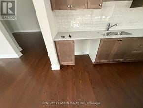Ottawa apartment for rent - A kitchen with wooden floors and white subway tiles on the wall.