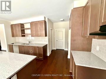 Ottawa apartment for rent - A kitchen with brown cabinets and white countertops.