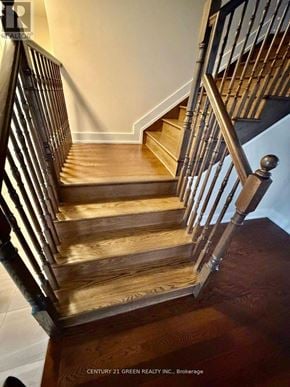 Ottawa apartment for rent - A wooden staircase with a metal railing.