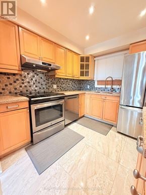 Markham (Markville) apartment for rent - A kitchen with orange cabinets and a black and white tiled backsplash.