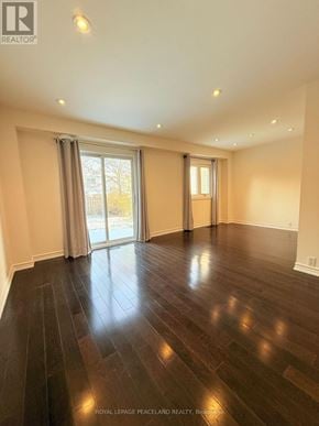 Markham (Markville) apartment for rent - A spacious room with wooden floors and sliding glass doors.