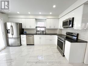 Vaughan (Brownridge) apartment for rent - A modern kitchen with white cabinets and stainless steel appliances.