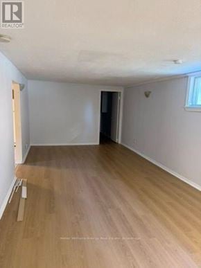 Pickering (West Shore) apartment for rent - A room with wooden flooring and white walls.